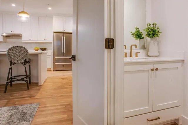 a kitchen with stainless steel appliances a refrigerator and a table