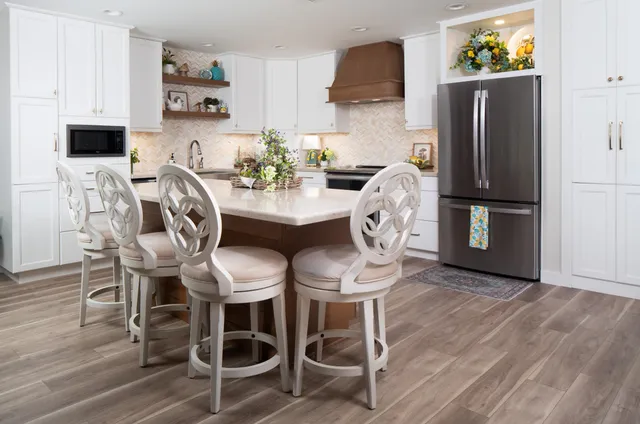 a dining room with furniture a chandelier and wooden floor