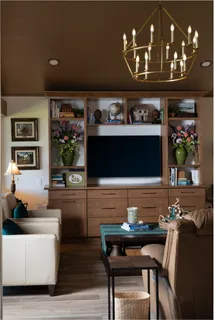 a living room with furniture flat screen tv and a floor to ceiling window