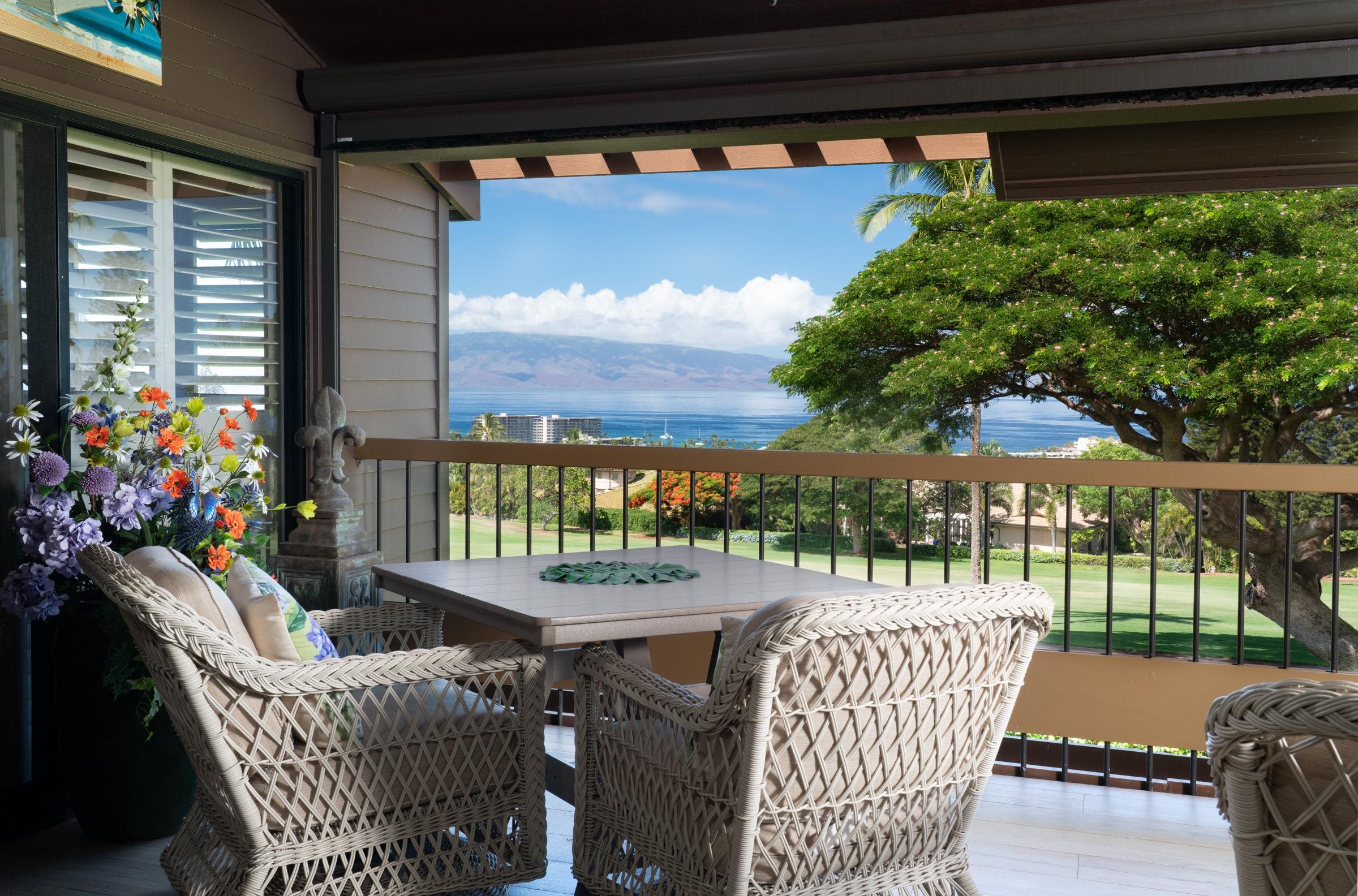 50 Puu Anoano Street, Unit 2804 Lahaina, HI 96761 - Photo 20 of 49 a view of a patio with a table chairs and a floor to ceiling window
