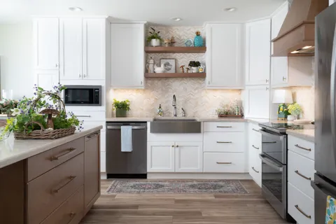 a kitchen with white cabinets and stainless steel appliances