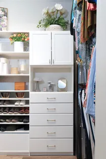 a view of walk in closet with clothes and shoes