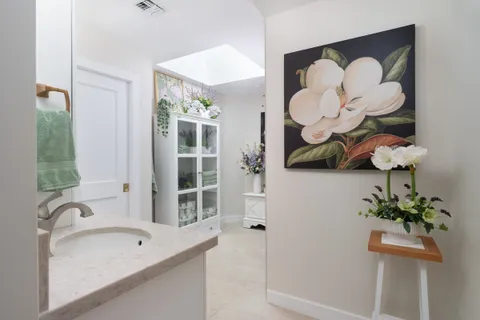 a bathroom with a sink mirror and shower