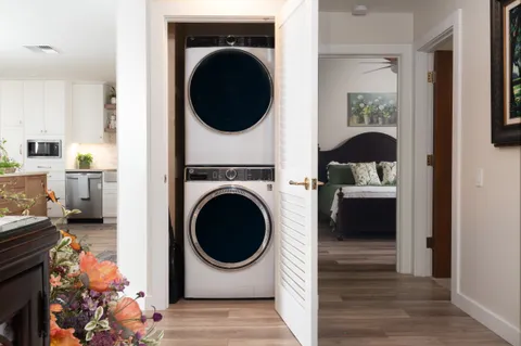 a bedroom with a bed and a painting on the wall