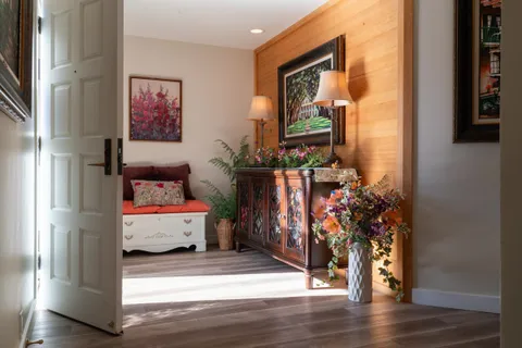 a living room with furniture and a potted plant