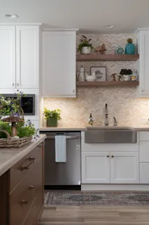 a kitchen with stainless steel appliances granite countertop a sink and a stove