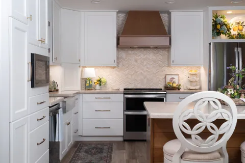 a kitchen with a sink a stove and cabinets