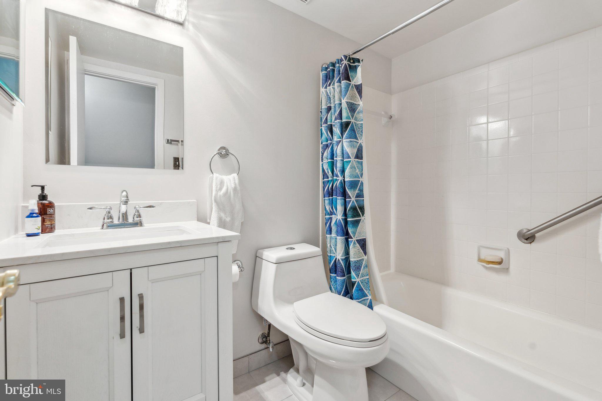 10108 Hellingly Place, Unit 300 Gaithersburg, MD 20886 - Photo 14 of 22 a bathroom with a sink toilet and shower