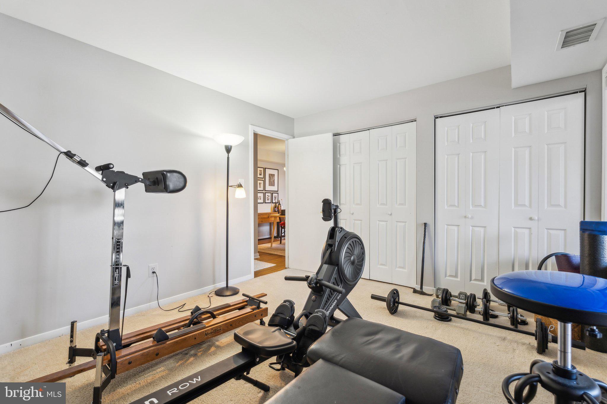 10108 Hellingly Place, Unit 300 Gaithersburg, MD 20886 - Photo 16 of 22 a view of a workspace with furniture and a gym machine