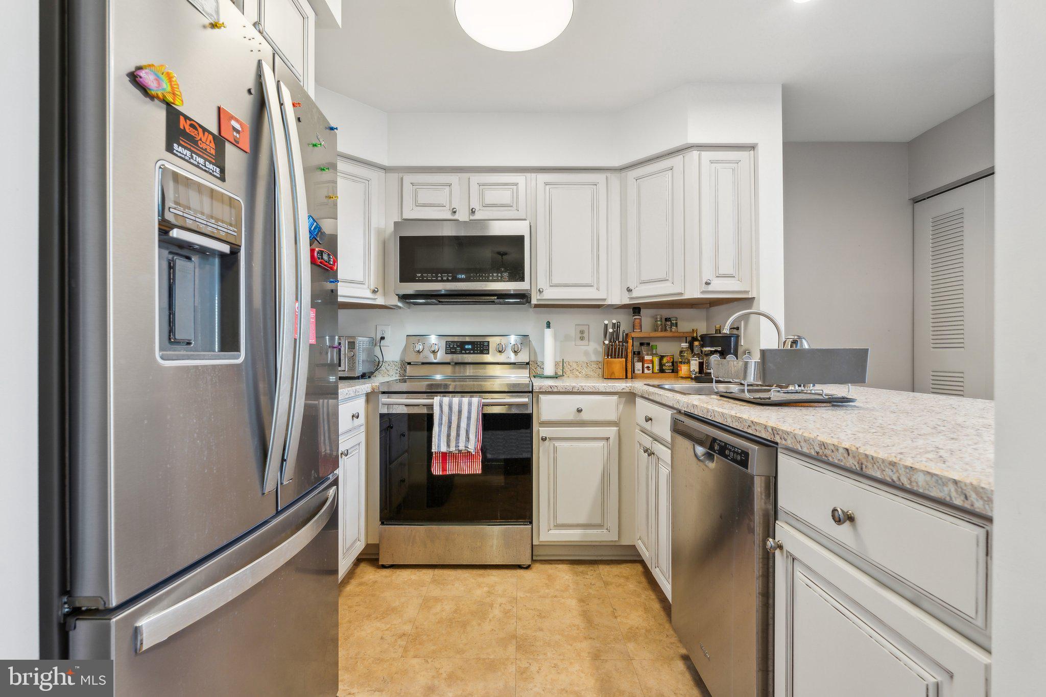 10108 Hellingly Place, Unit 300 Gaithersburg, MD 20886 - Photo 2 of 22 a kitchen with stainless steel appliances granite countertop a refrigerator sink and microwave