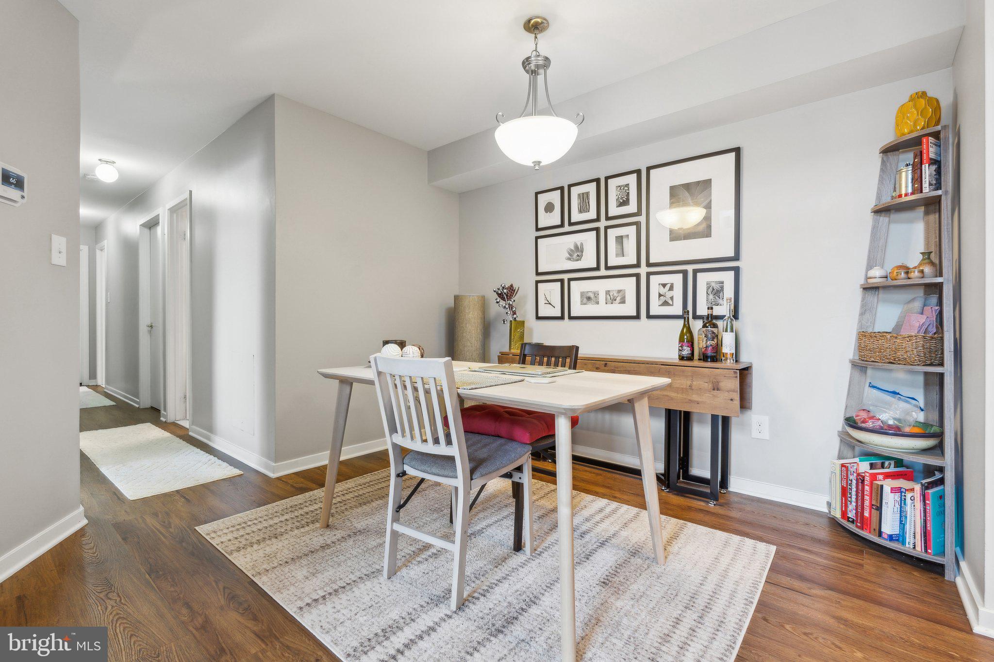 10108 Hellingly Place, Unit 300 Gaithersburg, MD 20886 - Photo 5 of 22 a dining room with furniture and wooden floor