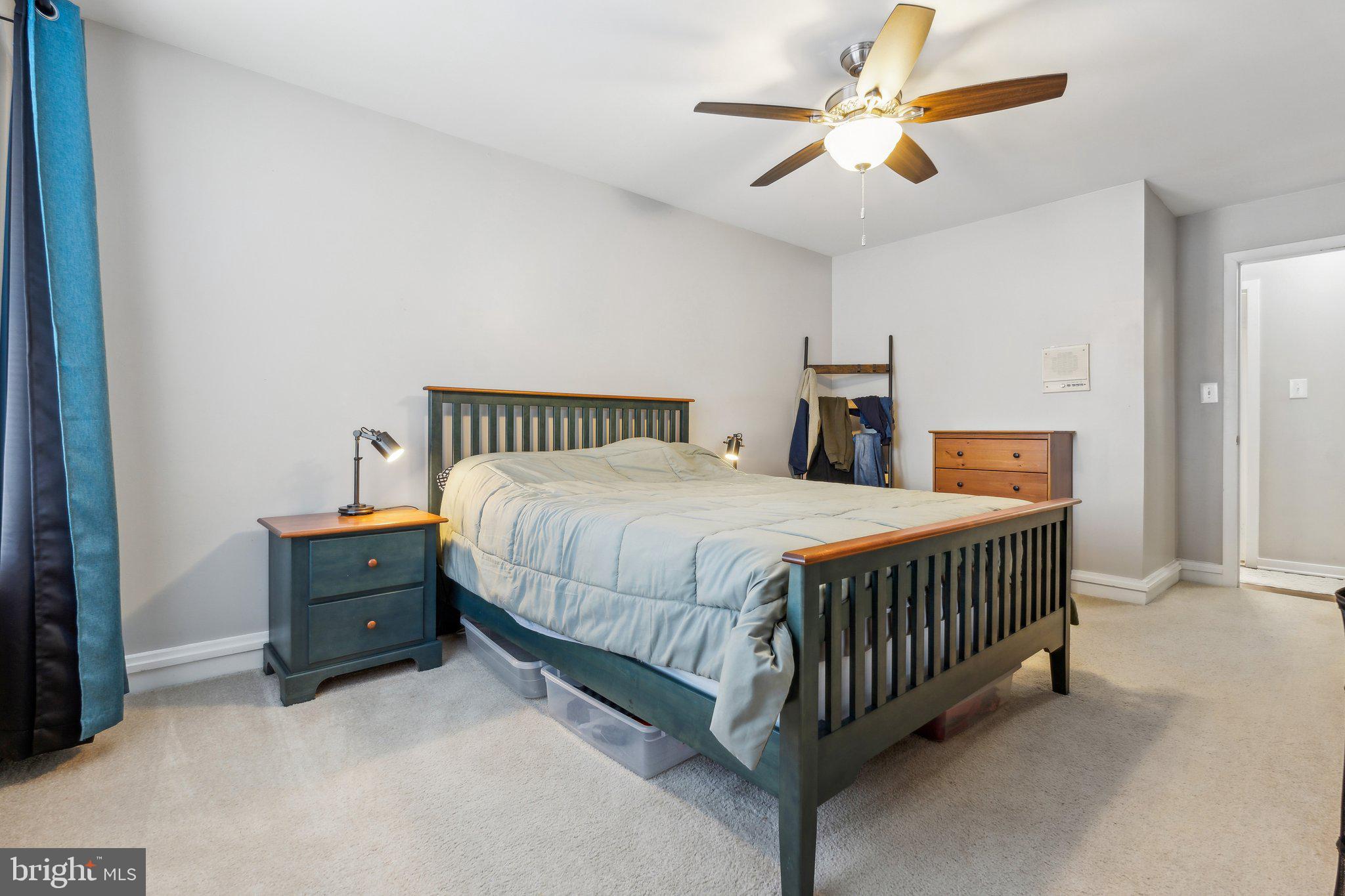 10108 Hellingly Place, Unit 300 Gaithersburg, MD 20886 - Photo 10 of 22 a bedroom with a bed and a chandelier