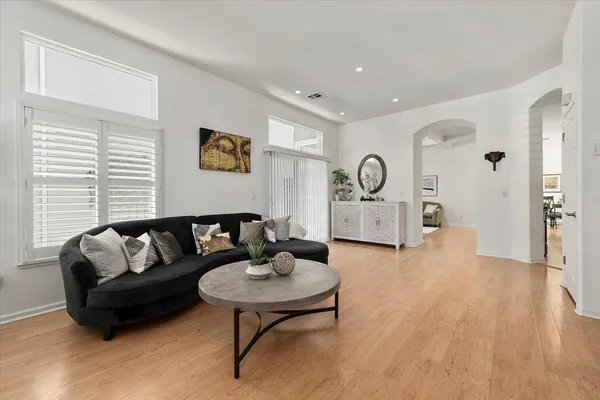 a living room with furniture and a wooden floor