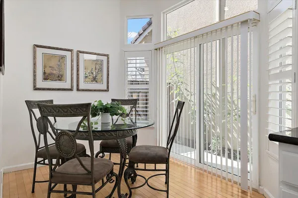 a view of a dining room with furniture window and wooden floor