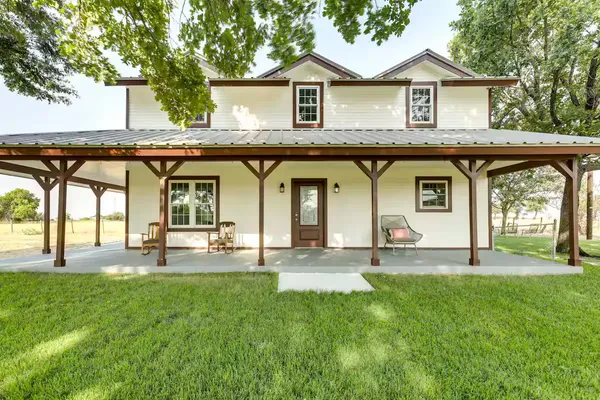 a view of a house with a backyard and a patio
