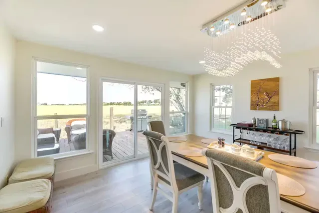 a view of a dining room with furniture and a chandelier