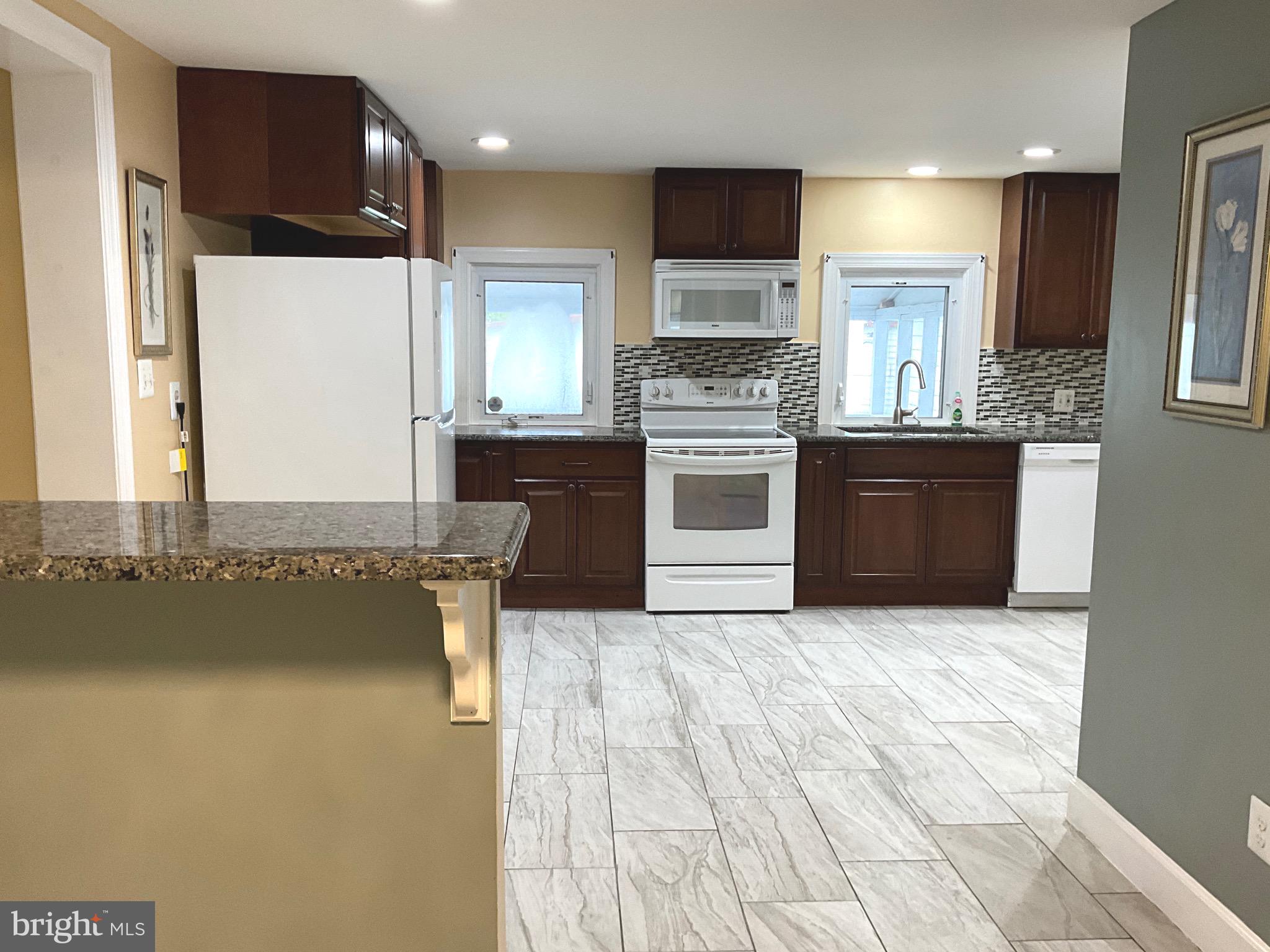 86 Kelley Road Fredericksburg, VA 22405 - Photo 10 of 36 a kitchen with stainless steel appliances a refrigerator and a stove top oven