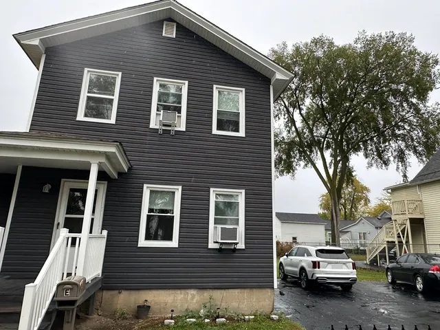 a front view of a house with parking space
