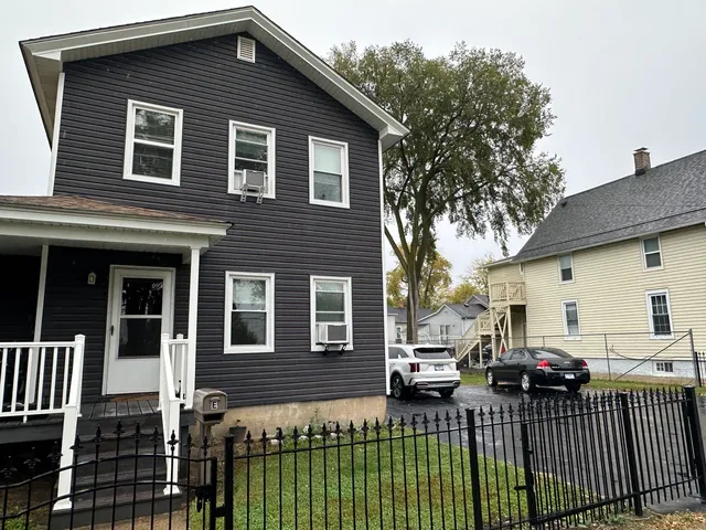 a view of a house with a wooden fence