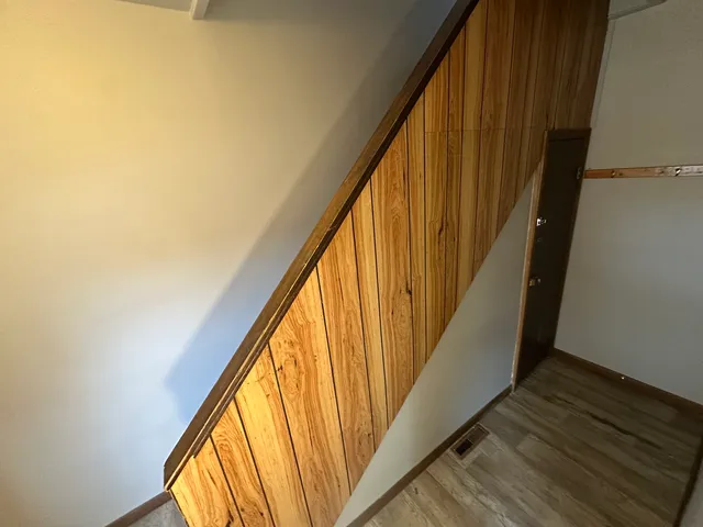 a view of a balcony with wooden floor and stairs