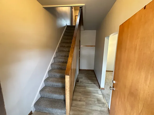 a view of entryway and gallery with wooden floor