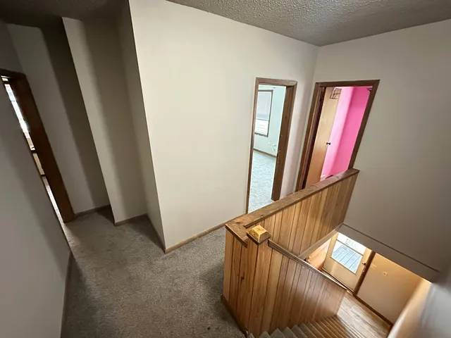 a view of a hallway with staircase