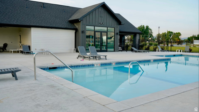 412 West 3025th Street South Logan, UT 84321 - Photo 33 of 34 Community pool featuring a dark-tiled shingle roof, white horizontal siding, and dark vertical siding