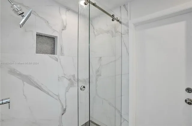 a bathroom with a shower and a sink