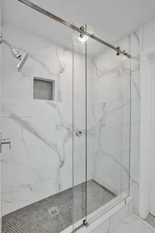 a bathroom with a glass shower door