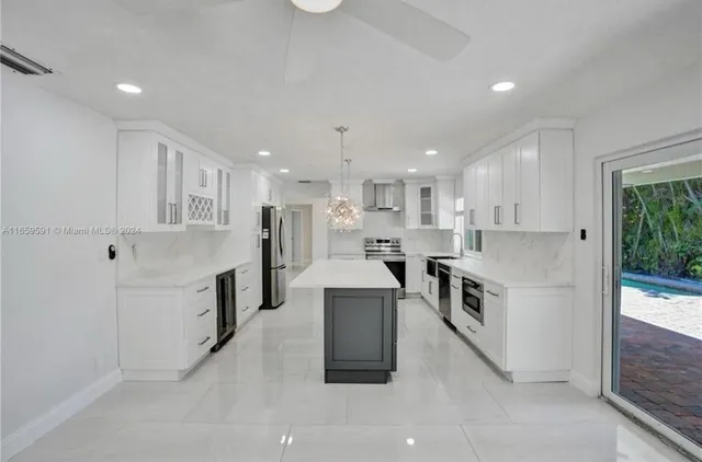 a large white kitchen with stainless steel appliances