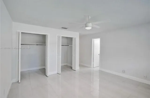 a bathroom with a double vanity sink and a toilet
