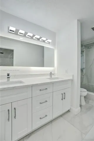 a bathroom with a shower and toilet