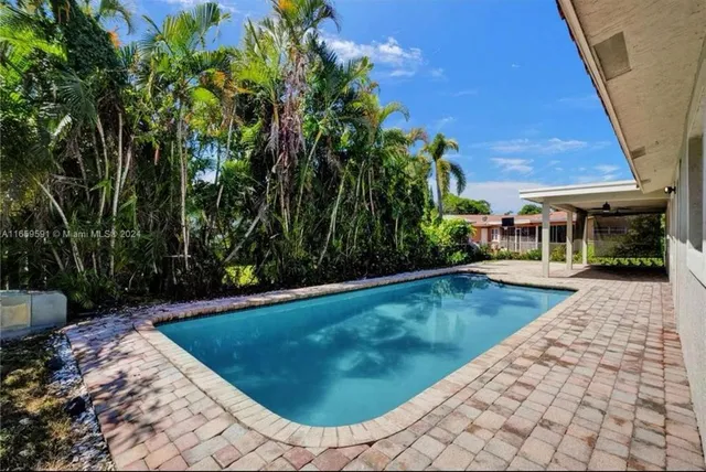 a kitchen with stainless steel appliances kitchen island a refrigerator and a sink