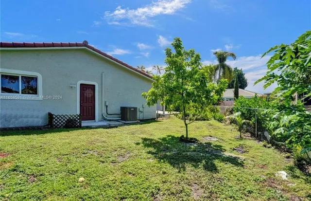a kitchen with stainless steel appliances kitchen island a chandelier and refrigerator