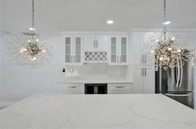 a kitchen with stainless steel appliances a refrigerator and a stove top oven