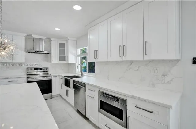 a view of kitchen with kitchen island stainless steel appliances refrigerator oven and cabinets