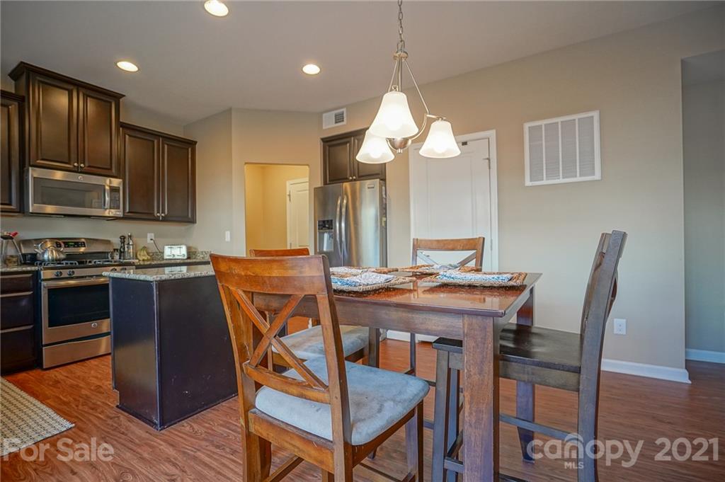 285 Almora Loop Mooresville, NC 28115 - Photo 11 of 45 a view of a dining room with furniture and wooden floor