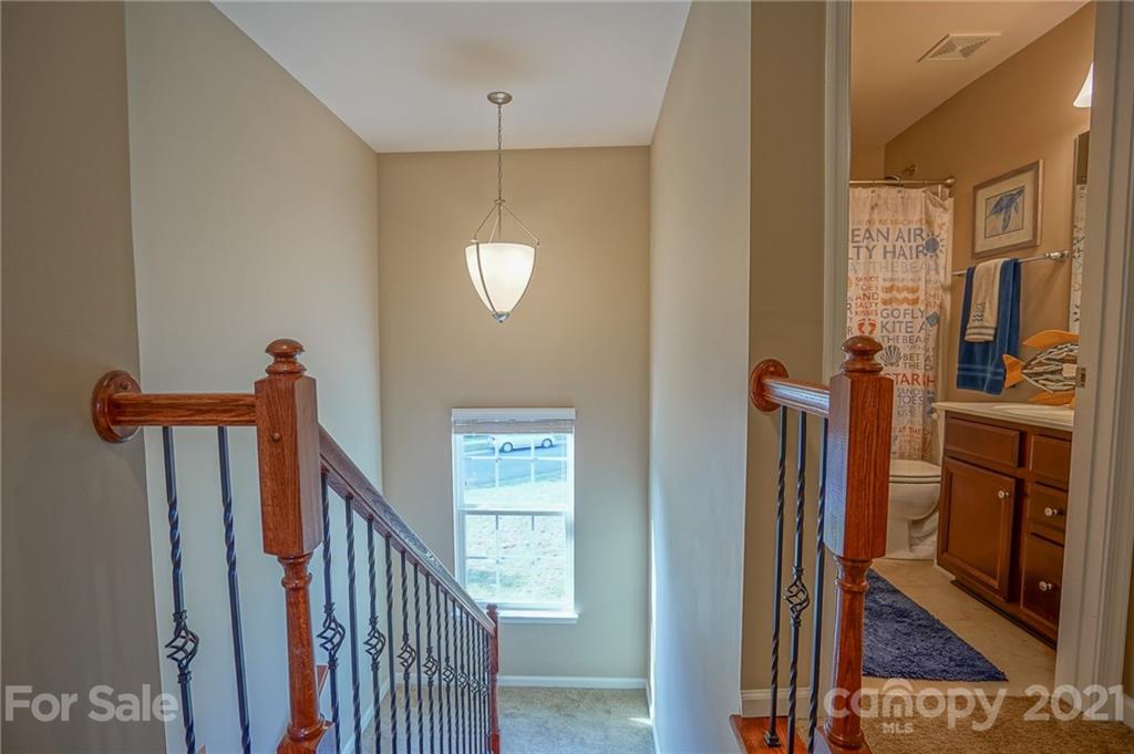 285 Almora Loop Mooresville, NC 28115 - Photo 16 of 45 a view of a hallway with wooden floor and staircase