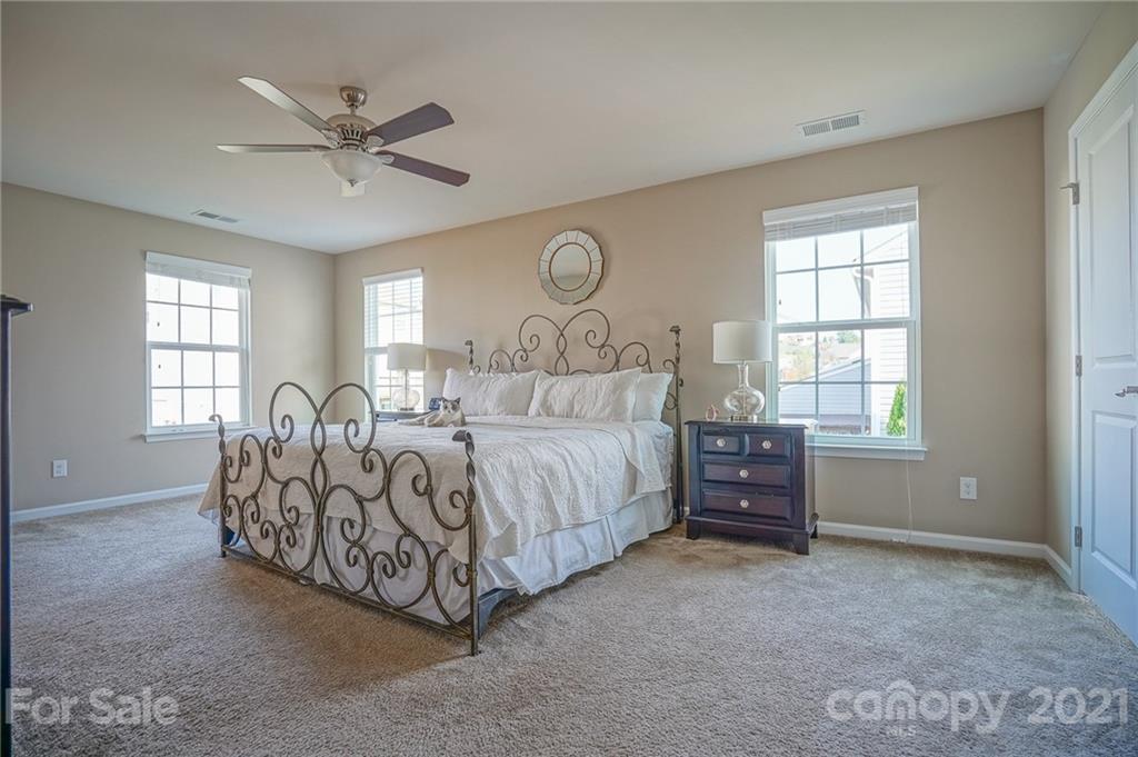 285 Almora Loop Mooresville, NC 28115 - Photo 17 of 45 a spacious bedroom with a bed and window
