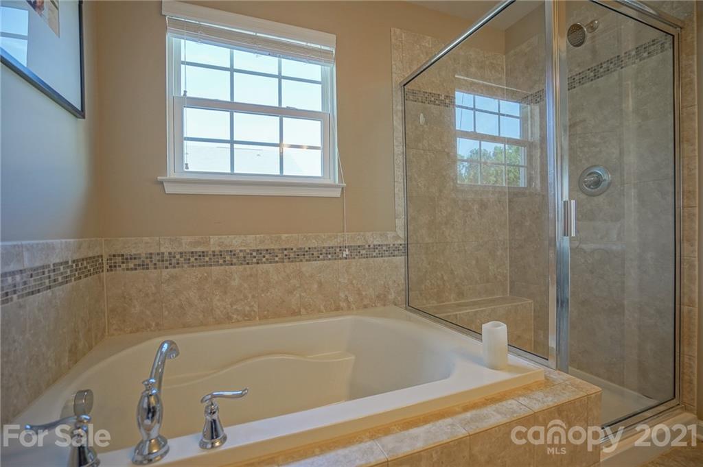 285 Almora Loop Mooresville, NC 28115 - Photo 20 of 45 a bathroom with a tub and a shower