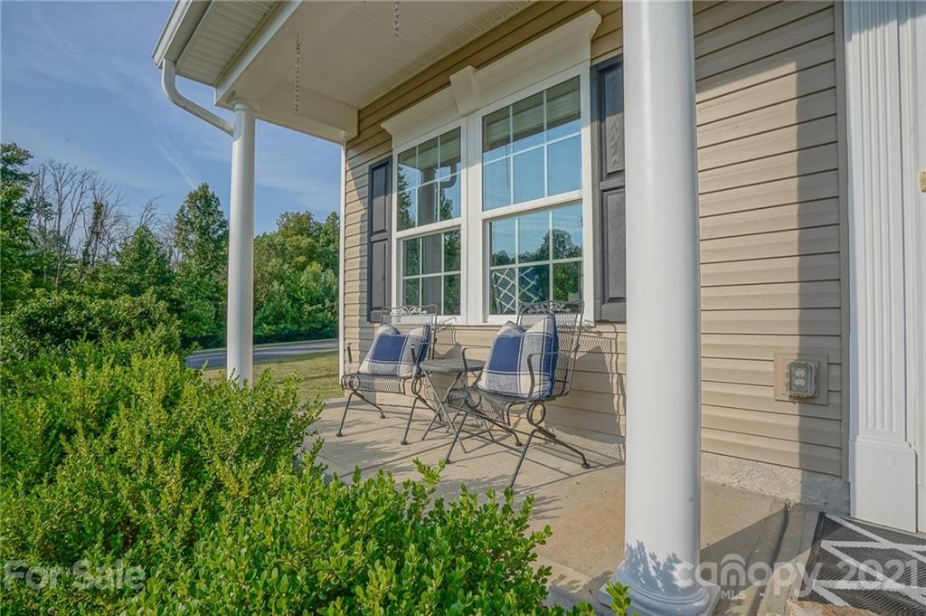 285 Almora Loop Mooresville, NC 28115 - Photo 3 of 45 a building outdoor space with patio furniture and potted plants