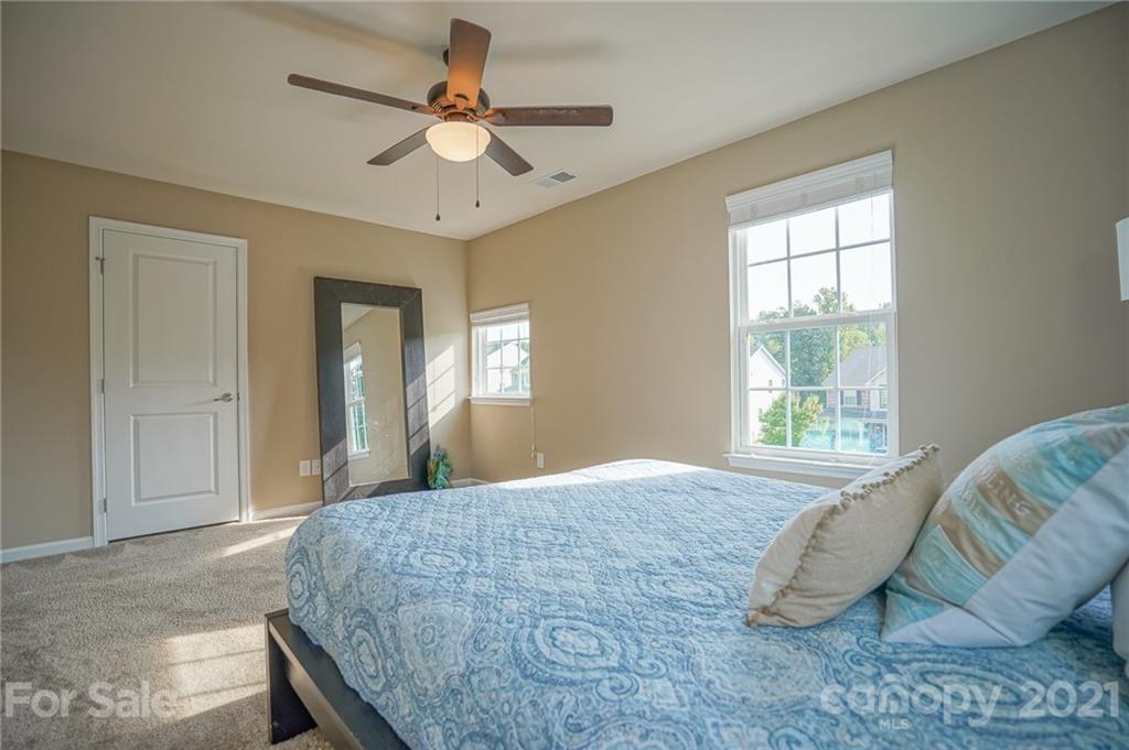 285 Almora Loop Mooresville, NC 28115 - Photo 25 of 45 a bedroom with a bed dresser and a window