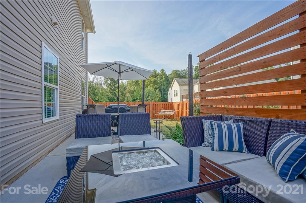 285 Almora Loop Mooresville, NC 28115 - Photo 32 of 45 a view of a patio with couches chairs and a potted plant