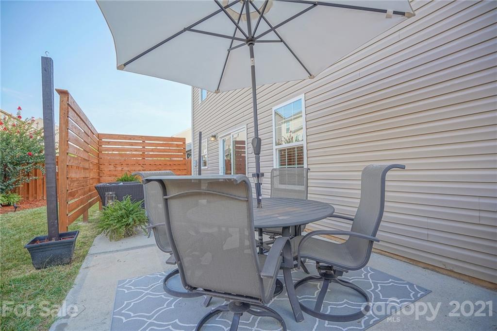 285 Almora Loop Mooresville, NC 28115 - Photo 34 of 45 a patio with table and chairs and potted plants