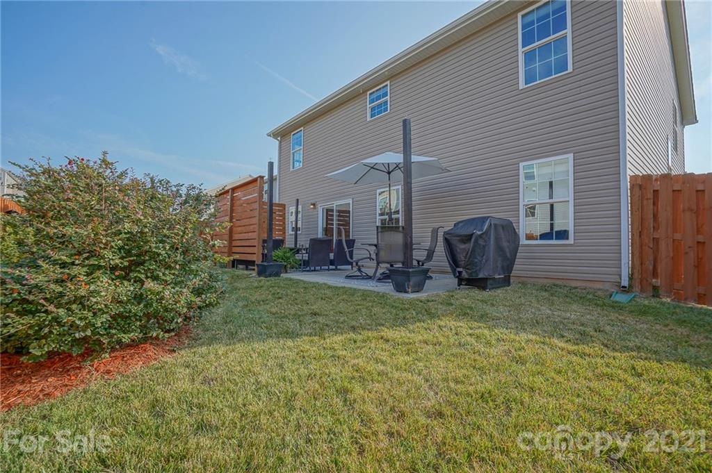 285 Almora Loop Mooresville, NC 28115 - Photo 35 of 45 a view of a house with a backyard and a tree