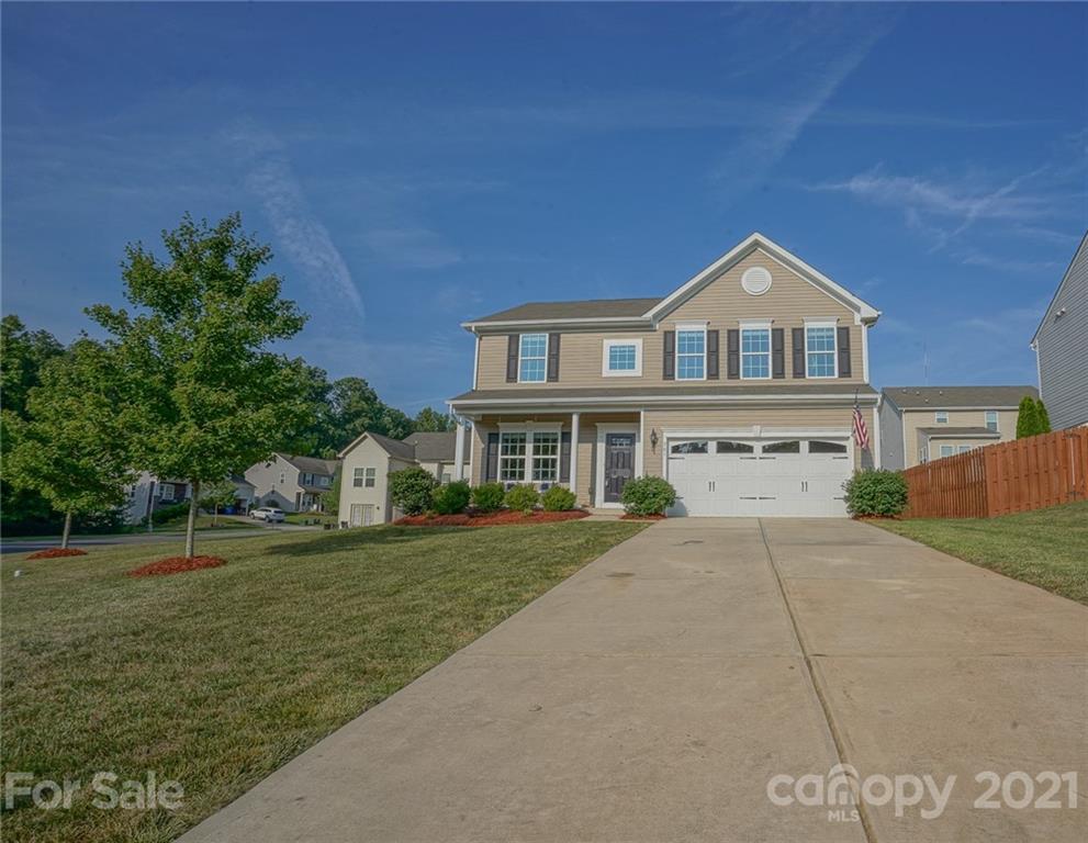 285 Almora Loop Mooresville, NC 28115 - Photo 41 of 45 a front view of a house with a garden and yard