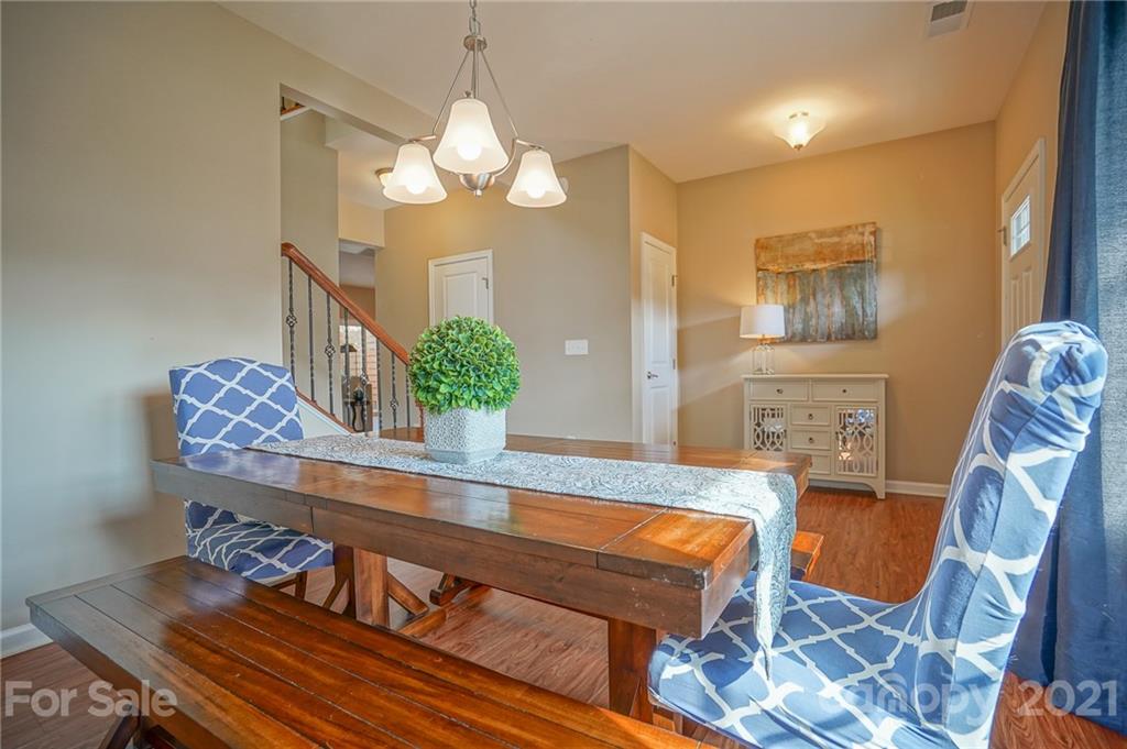 285 Almora Loop Mooresville, NC 28115 - Photo 7 of 45 a living room with furniture and a chandelier