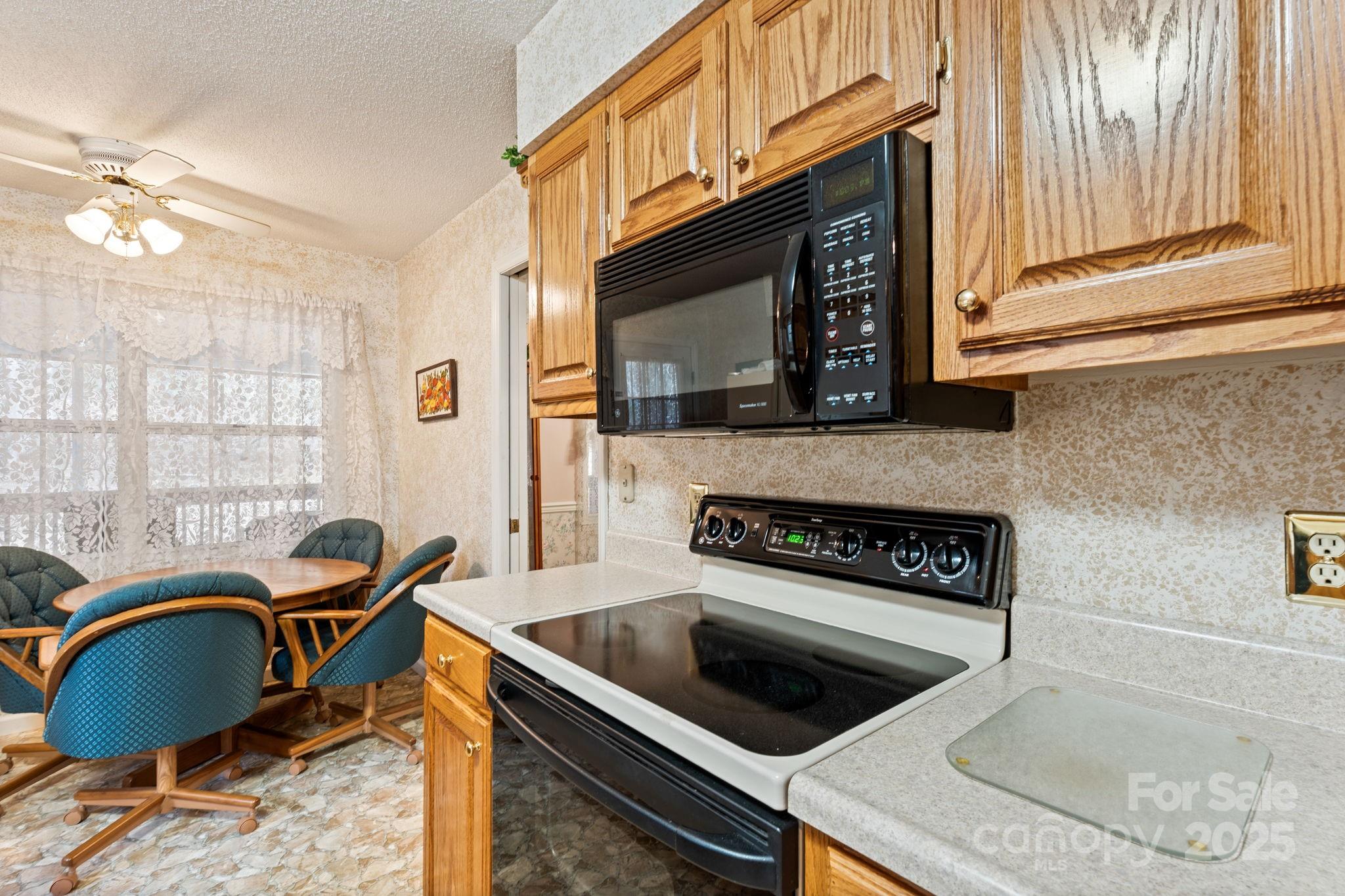 184 Trimont Mountain Road Franklin, NC 28734 - Photo 12 of 41 a kitchen with granite countertop a stove a sink and a microwave