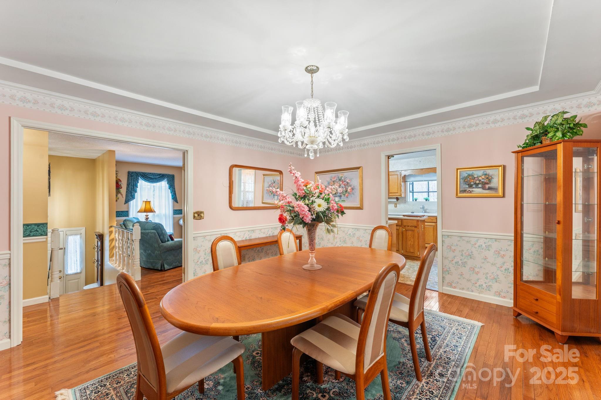 184 Trimont Mountain Road Franklin, NC 28734 - Photo 14 of 41 a dining room with furniture a chandelier and wooden floor