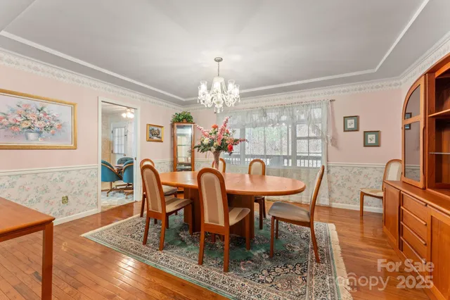 a view of a dining room with furniture and chandelier
